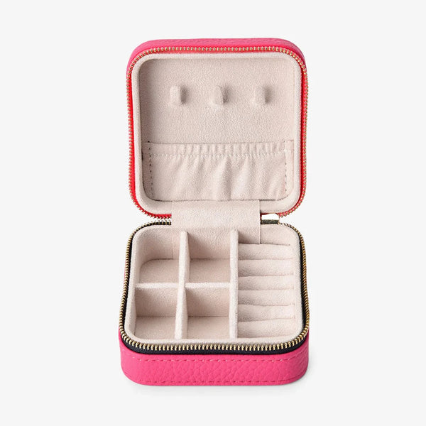 Pink jewelry case with earrings on a white background
