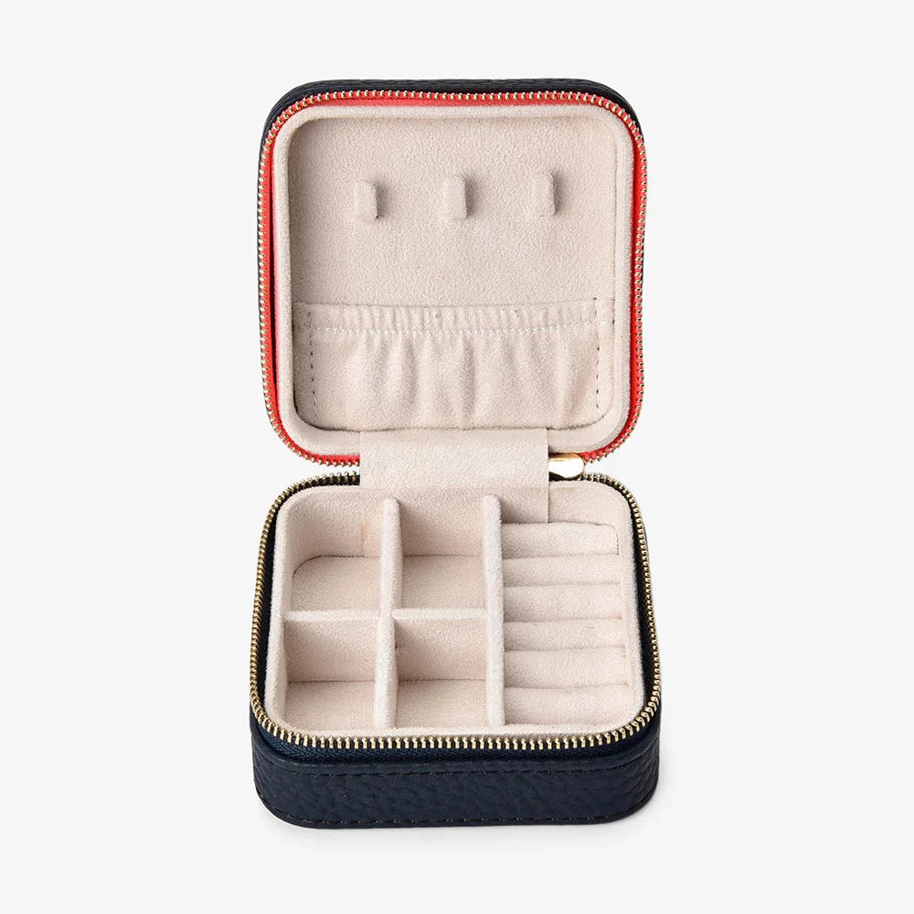 Open jewelry case with compartments on a white background