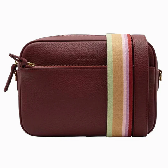 Brown leather crossbody bag with a colorful striped strap on a white background