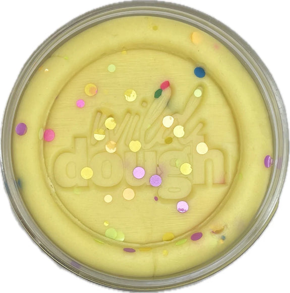 Yellow dough with colorful sprinkles in a container labeled 'dough'.