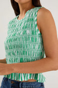 Green and white patterned sleeveless top worn by a person on a plain background