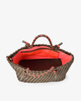 Woven handbag with red interior on a white background