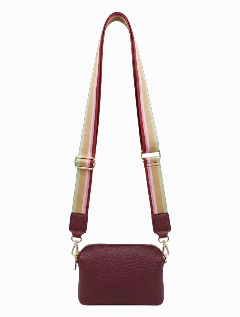 Maroon handbag with a colorful strap on a white background