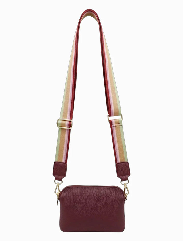 Maroon handbag with a colorful strap on a white background