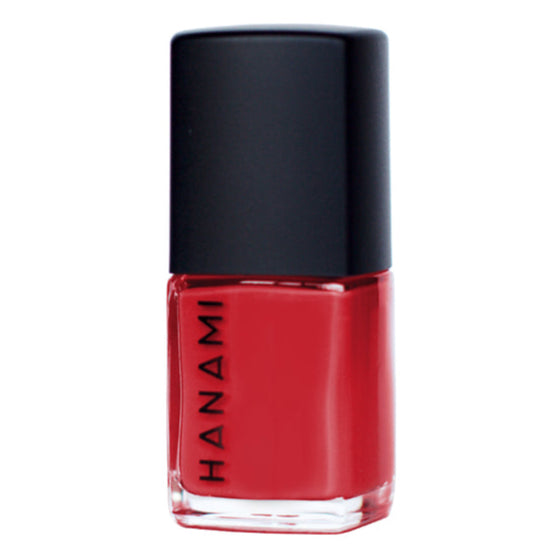 Red nail polish bottle with black cap on a white background