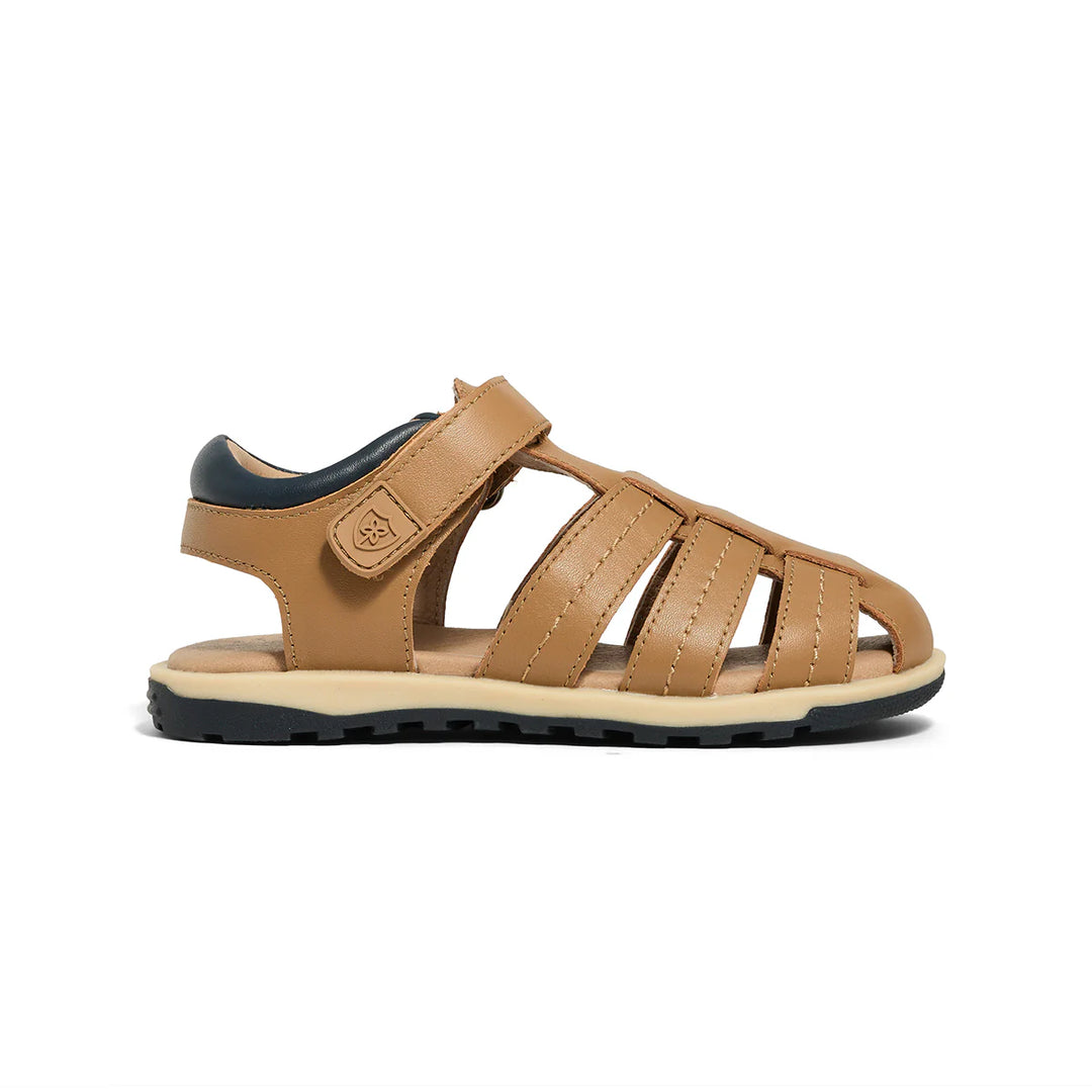 Tan sandal with black sole on a white background