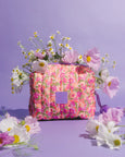 Floral-patterned bag with flowers on a purple background