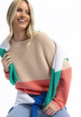 Woman wearing a colorful sweater with a white background