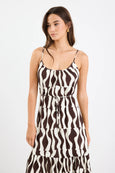 Woman wearing a black and white patterned dress on a white background