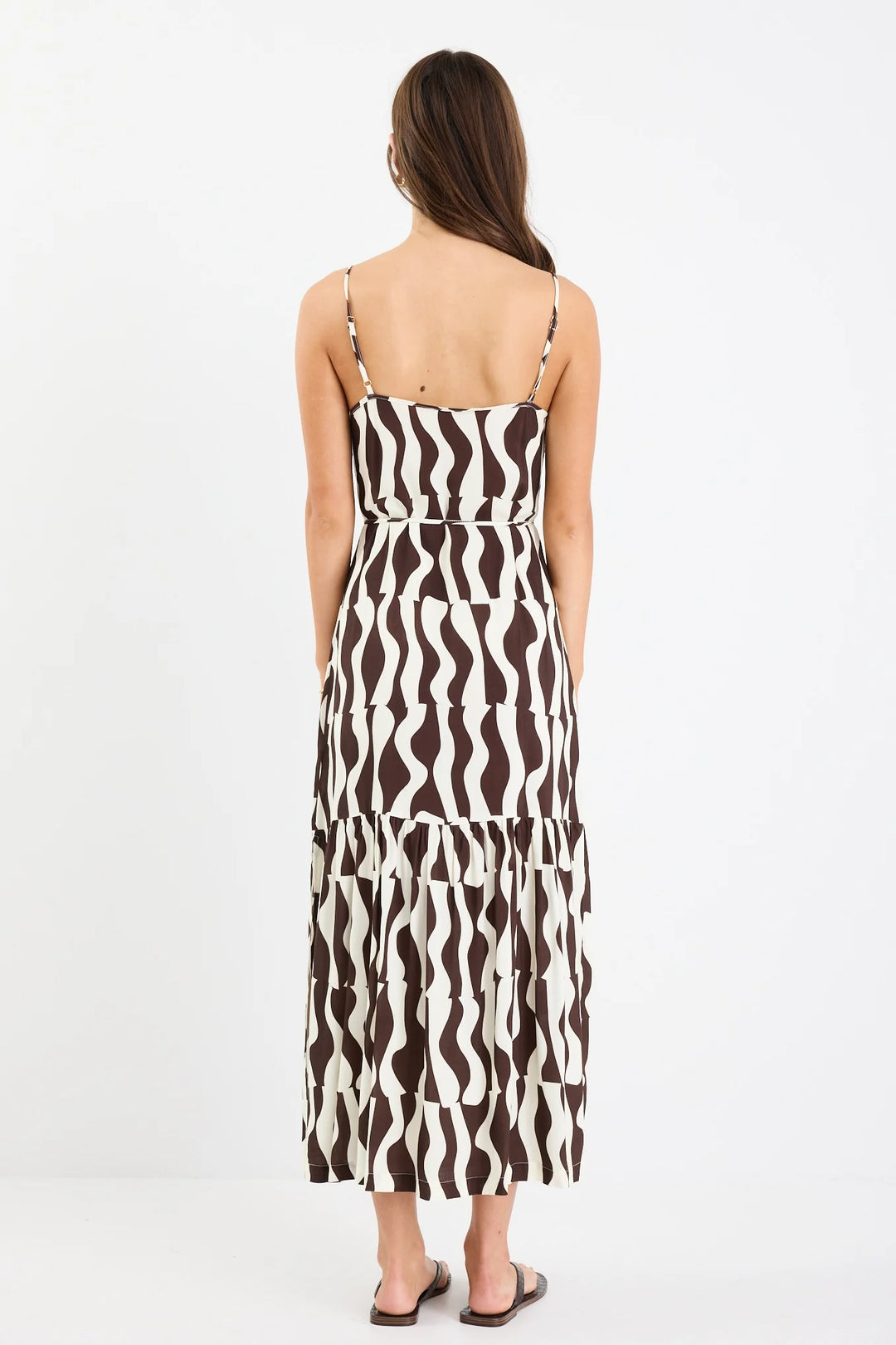 Woman wearing a black and white patterned dress on a white background