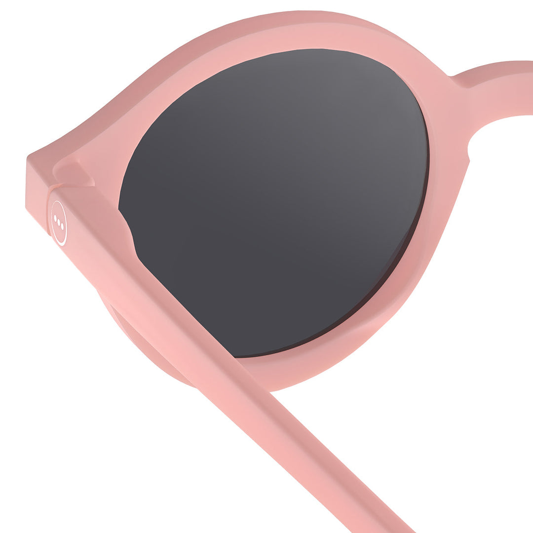 Pink sunglasses with dark lenses on a white background