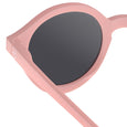 Pink sunglasses with dark lenses on a white background