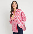 Woman wearing a red and white striped shirt and dark blue jeans on a white background