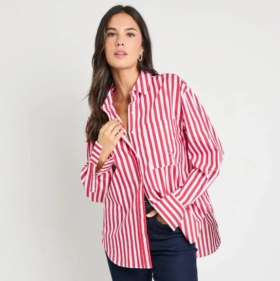 Woman wearing a red and white striped shirt and dark blue jeans on a white background
