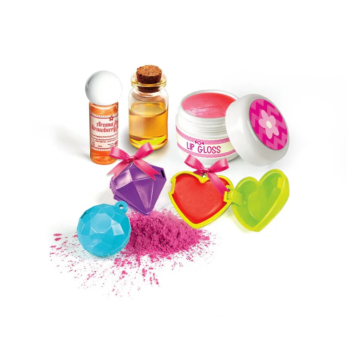 Collection of colorful makeup items including lip gloss, powders, and containers on a white background