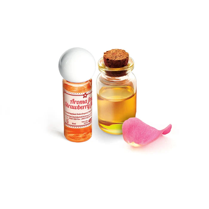 Small bottle labeled 'Aroma for Strawberry' next to a glass jar with a cork lid on a white background