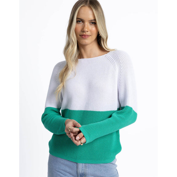 Woman wearing a white and green sweater on a white background