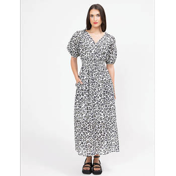 Woman wearing a black and white patterned dress on a white background