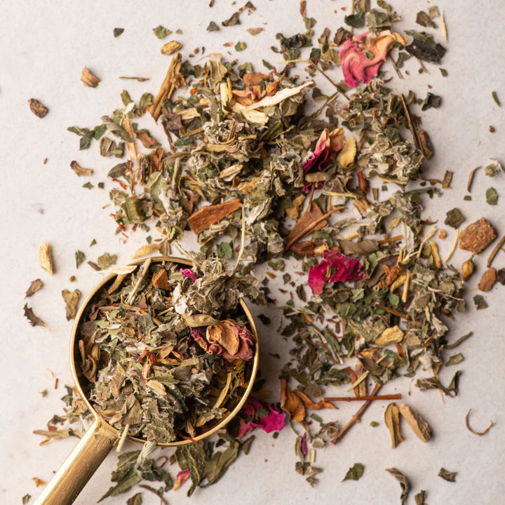 Spice mix with a gold spoon on a light background