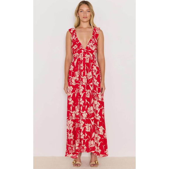 Woman wearing a red floral dress on a white background