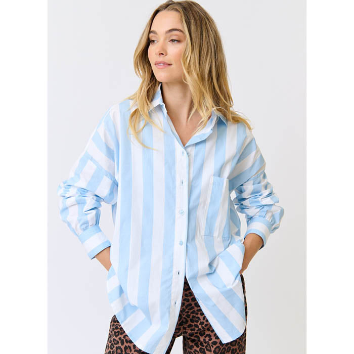 Woman wearing a light blue and white striped shirt with a plain background