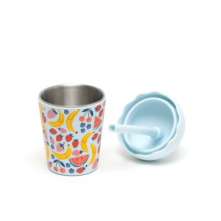 Children's stainless steel cup with fruit pattern and matching lid on a white background