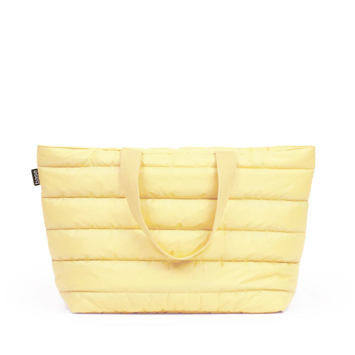 Yellow quilted tote bag on a white background