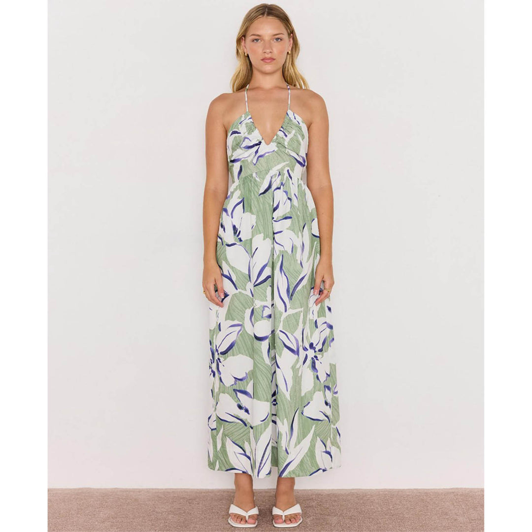Woman wearing a floral dress on a plain background