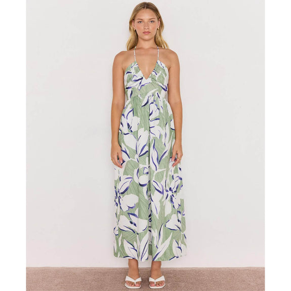 Woman wearing a floral dress on a plain background