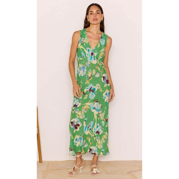 Woman wearing a green floral dress against a white background