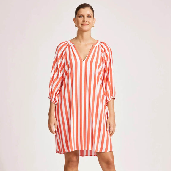 Woman wearing a eb  ive  red and white striped dress on a plain background