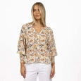Woman wearing a floral blouse and white pants on a white background