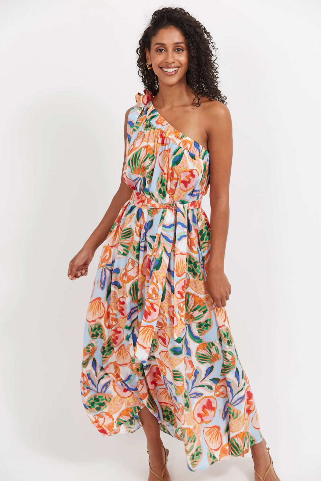 Woman wearing a colorful Haven floral dress on a white background