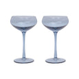 Two blue cocktail glasses on a white background