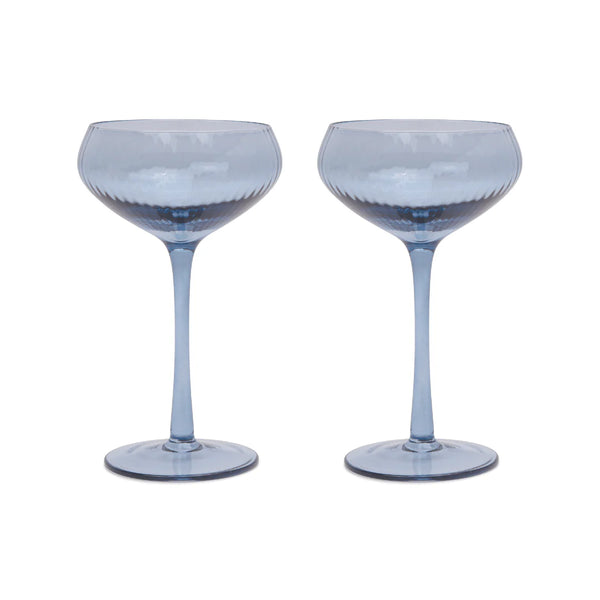 Two blue cocktail glasses on a white background