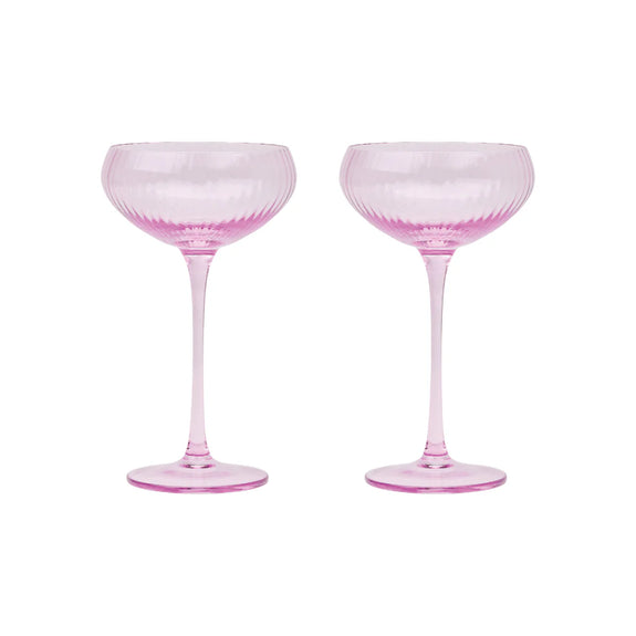 Two pink cocktail glasses on a white background