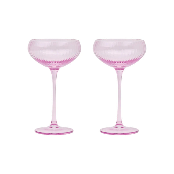 Two pink cocktail glasses on a white background