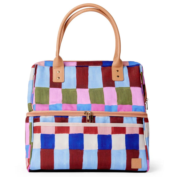 Multicolored checkered cooler bag with brown handles and trim on a white background