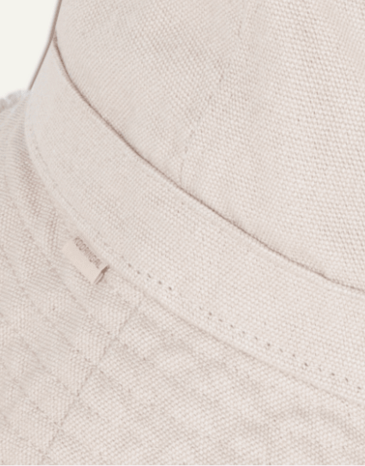 Close-up of a textured beige fabric with a brand label.