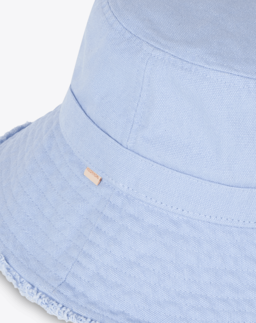 Light blue bucket hat with a brand tag on a white background