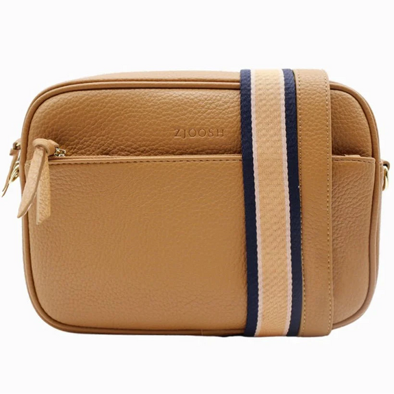 Tan leather crossbody bag with a striped strap on a white background