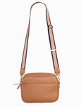 Tan crossbody bag with a strap on a white background