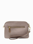 Beige handbag with gold zipper on a white background