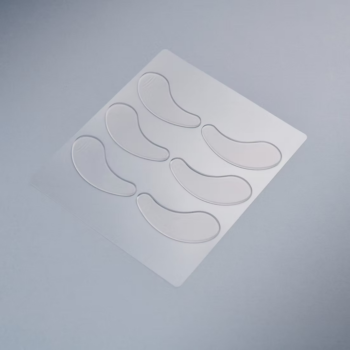 Set of clear silicone eye patched on a gray background