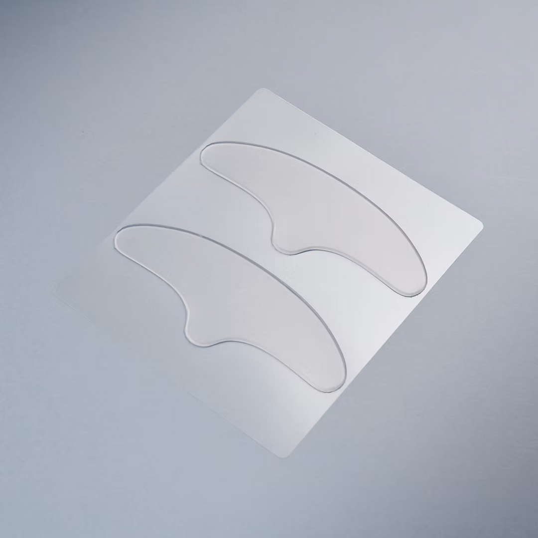 Two clear eye patches on a gray background
