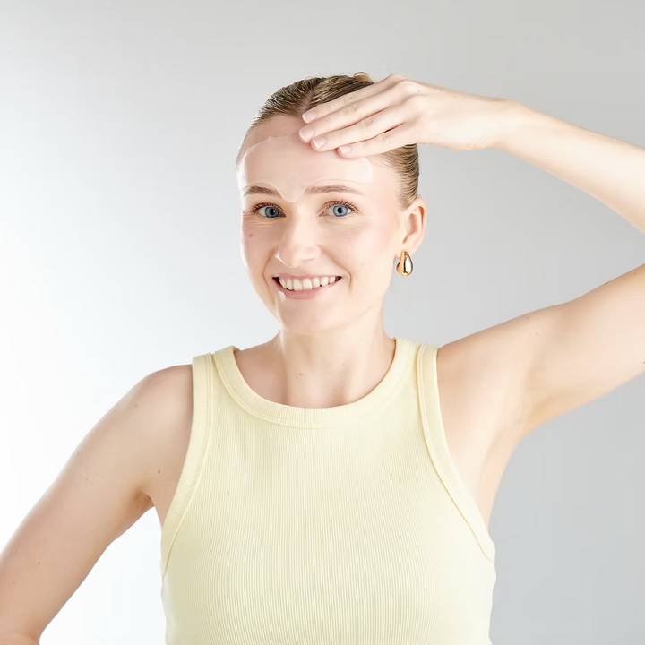 Woman in a yellow tank top with a neutral background