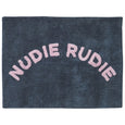 Denim rug with 'Nudie Rudie' text in pink on a white background