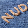 Textured letters 'WUD' on a blue textured surface