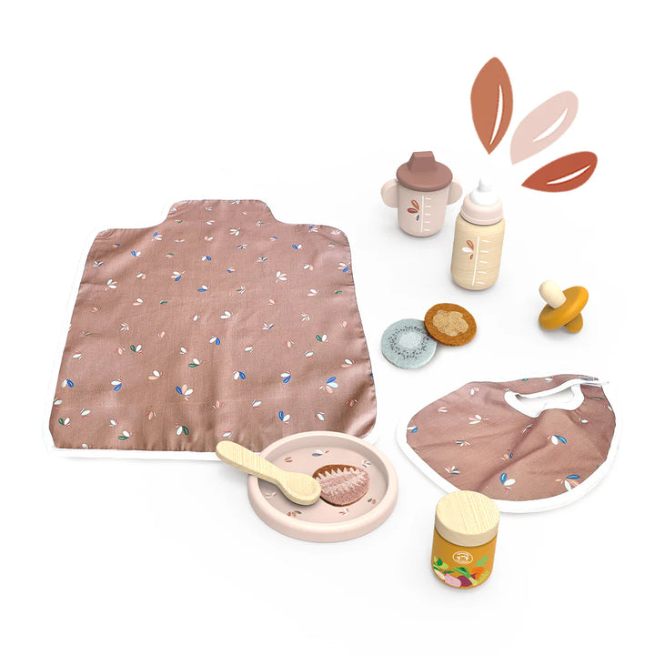 Collection of baby toys and items including a blanket, bottle, spoon, and pacifier on a white background.