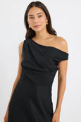 Woman wearing a black one-shoulder dress on a white background